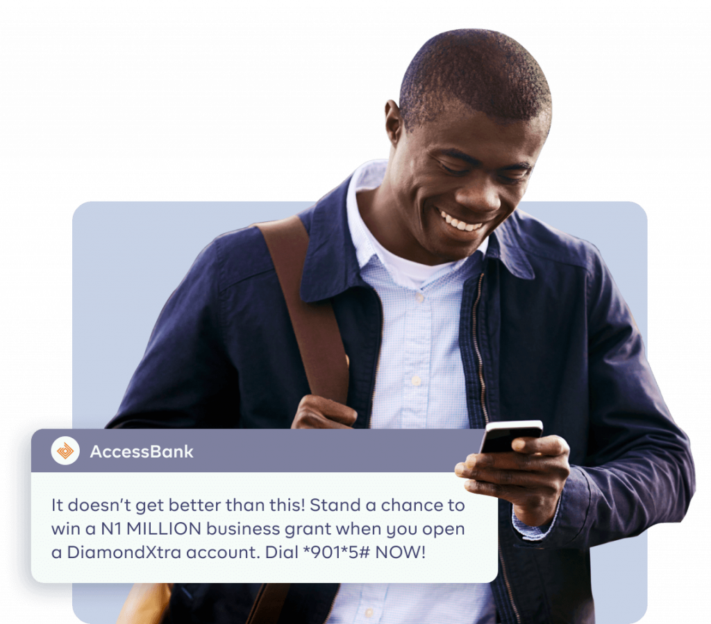 An image of a man smiling and receiving a message from his bank