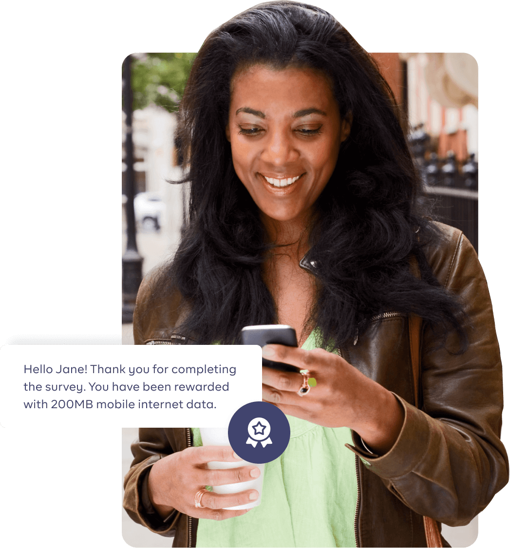 Image of a woman pressing her phone and smiling